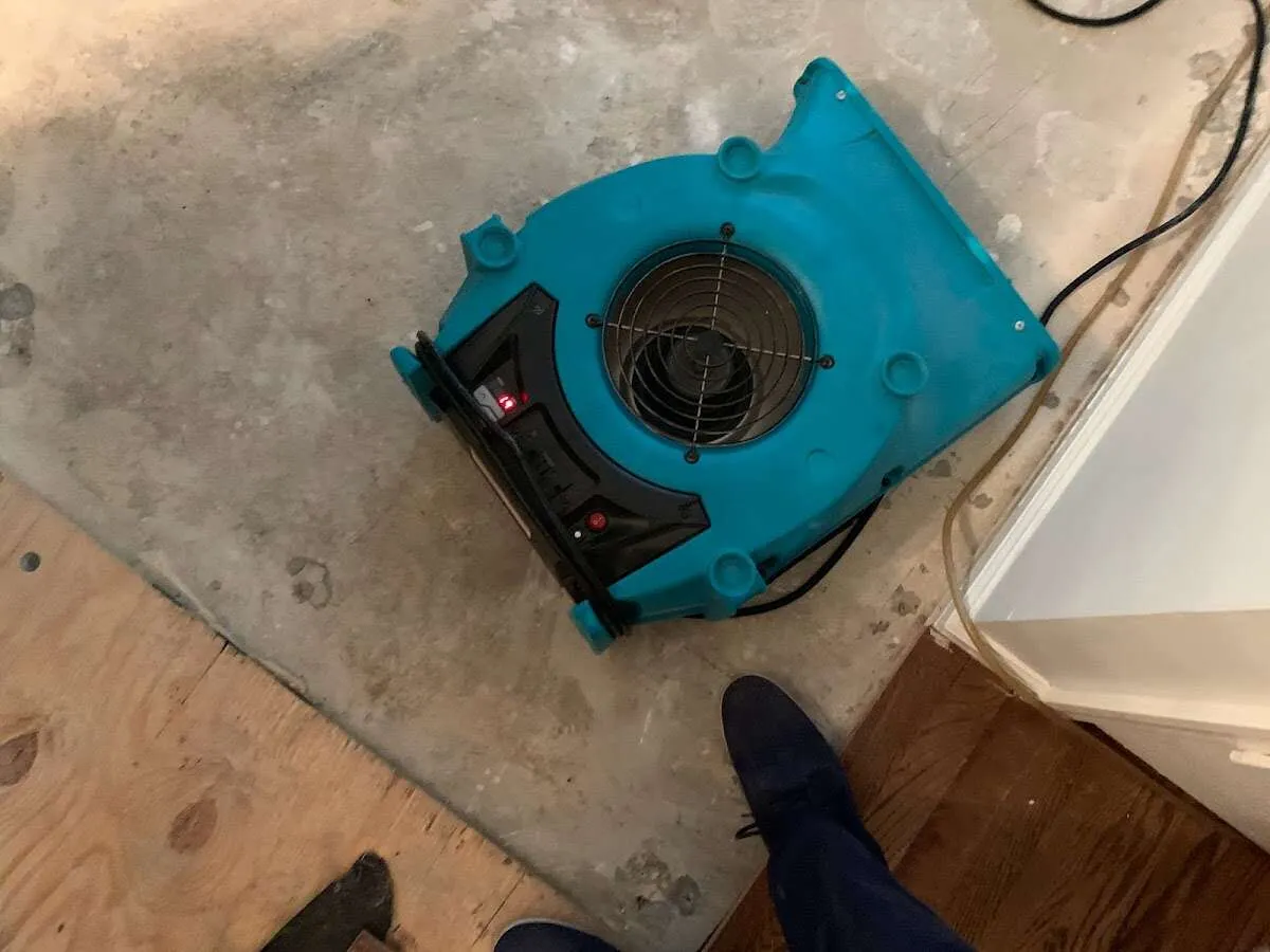 Air mover drying subfloor during Leak Detection & Repair in Pekin